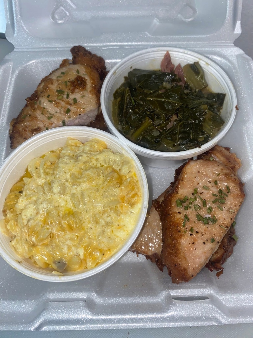 A Sunday plate of pork chops with macaroni and collard greens
